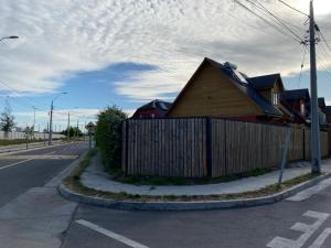 a house on the side of a road with a fence at Casa Parque Rauquen in Curicó