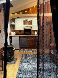 a kitchen with wooden cabinets and a stove at Off the Beaten Shack in North Hill