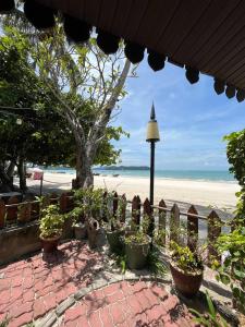 a patio with potted plants on the beach at Sandy Beach Resort By Casa Loma in Pantai Cenang