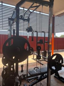 a gym with a simulator with weights and machines at Tomato Backpackers in Bundaberg