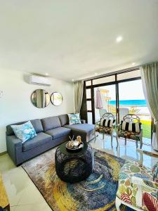 a living room with a couch and a table at Simla Luxury Apartments in Margate