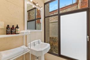 a bathroom with a sink and a window at King Charming Cottage - Walk to the River in Fremantle +15 photos