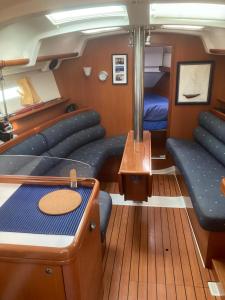 a room with a couch and a bed on a boat at Le Voilier dans la baie des Saintes in Terre-de-Haut