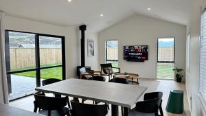 a dining room with a table and chairs and a large window at Remarkable Stay with Mountain View’s in Frankton Wharf