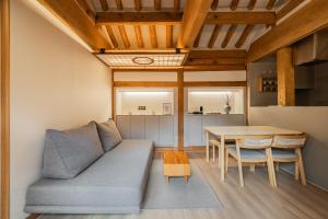 a living room with a couch and a table at Luxury hanok with private bathtub - SN06 in Seoul