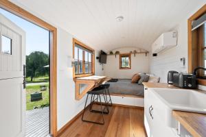 a tiny house with a bed and a kitchen at Camp Crusty Eldorado in Eldorado