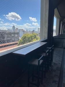 a bar with a view of a city from a window at Loft luminoso en Capital Federal in Buenos Aires