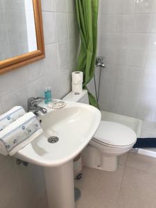 a bathroom with a white sink and a toilet at VV YELYMAR. PLAYA DE ALOJERA in Alojera