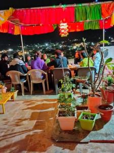 a group of people sitting at a restaurant at night at Hotel Desert in Jaisalmer