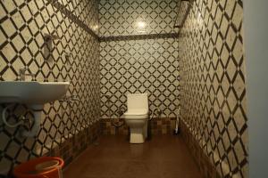 a bathroom with a toilet and a sink at Honey hut. in Anachal