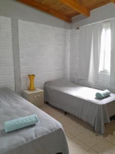 a bedroom with two beds and a window at La Casita de Irene in Puerto Rico
