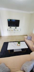 a living room with a couch and a coffee table at Pine Tree Entire House 2B Gated Com in Higuey