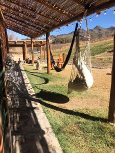 a hammock hanging from a pergola at Cabaña La Apacheta Cachi Salta in Cachí