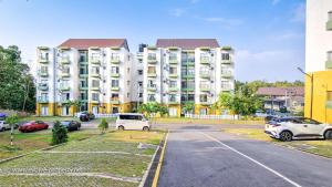 un gran edificio de apartamentos con coches aparcados en un aparcamiento en Luxurious 2 bedroom apartment - Ariyana Resort Apartments -Athurugiriya en Colombo