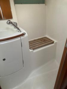 a small bathroom with a sink and a toilet at Le Voilier dans la baie des Saintes in Terre-de-Haut