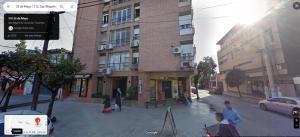 a group of people on a street in front of a building at Departamento Céntrico Tucumán 1A in San Miguel de Tucumán