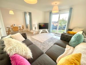 a living room with a couch and a tv at Stunning Home Driveway and Garden FREE PRIVATE PARKING - Northampton in Northampton