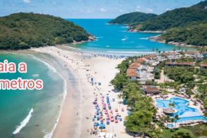 a view of a beach with people in the water at Casa com Piscina e churrasqueira/ mar casado in Guarujá