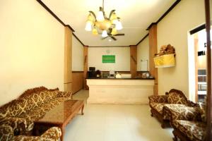 a waiting room with couches and a cash register at Tori Inn in Sanur +37 photos