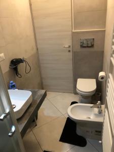 a bathroom with a toilet and a sink and a shower at B&B Al Cavour in Acireale
