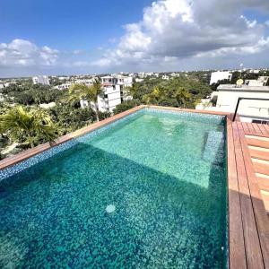 a large swimming pool on top of a building at Mya Black Diamond 202 in Playa del Carmen