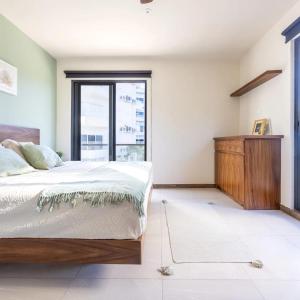 a bedroom with a large bed and a window at Mya Black Diamond 202 in Playa del Carmen +11 photos