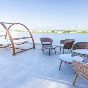 a group of chairs and tables on a patio at Mya Black Diamond 202 in Playa del Carmen