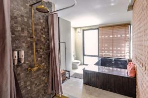 a bathroom with a walk in shower and a toilet at SriLanta Resort and Spa in Ko Lanta