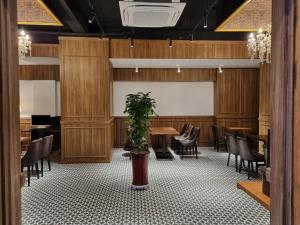 a dining room with wooden walls and tables and chairs at Angel Hotel in Busan