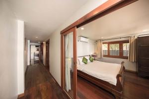a bedroom with a large bed and a window at SriLanta Resort and Spa in Ko Lanta