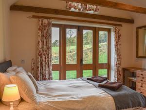 a bedroom with a bed and a large window at The Bull Pen - 17320 in Compton