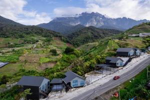 an aerial view of a village with a road and mountains at 929 Villa, kundasang in Kampong Kundassan