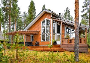 a cabin in the woods with a large window at KolinPilvi in Kolinkylä