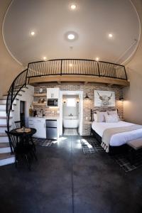 a bedroom with a large bed and a kitchen at Silo Suite 4- Near Zion National Park in La Verkin