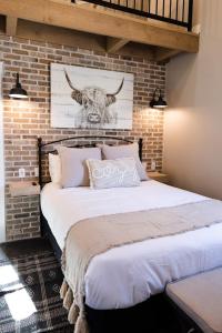 a bedroom with a large bed with a bull on the wall at Silo Suite 4- Near Zion National Park in La Verkin