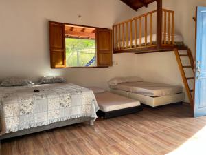 a bedroom with two beds and a loft at CABAÑA CAMPESTRE - San Gil in San Gil