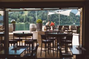 a restaurant with tables and chairs and a view of the water at Penzion Vila Prešeren in Bled