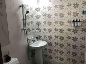 a bathroom with a sink and flowers on the wall at Green Stay in Suwon +27 photos
