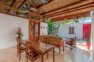 a dining room with a wooden table and chairs at Bali Ginger Suites & Villa in Seminyak