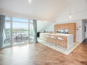 a kitchen with a counter and a large window at The Penthouse in Morfa Nefyn