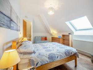 a bedroom with a bed and a skylight at The Penthouse in Morfa Nefyn