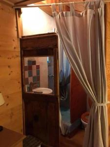a bathroom with a sink and a shower curtain at Maisonnette avec terrasse et vue imprenable in Théus +7 photos