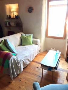 a living room with a couch and a coffee table at Maisonnette avec terrasse et vue imprenable in Théus
