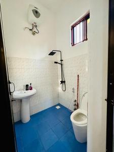 a bathroom with a toilet and a sink at Paje Home in Paje