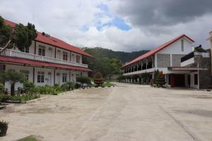 an empty street in a town with buildings at Hotel Ompu Herti in Balige