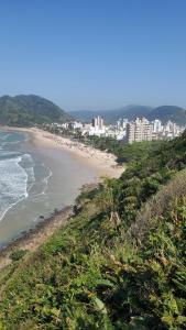 a view of a beach with buildings in the background at Guarujá - Praia do Tombo - Apartamento in Guarujá