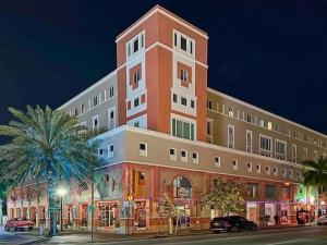 a large building on a city street at night at NEWLY Renovated condo 5 min from Airport in Miami