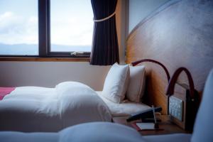 a hotel room with a bed and a window at Hotel Chourakukan Kyoto Gion 長楽館 京都 in Kyoto