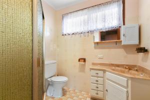 a bathroom with a toilet and a sink at Family Escape in Lakes Entrance +12 photos