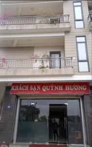 un hombre está de pie en la puerta de un edificio en Quỳnh Hương Hotel Phú Thọ, en Phú Thọ